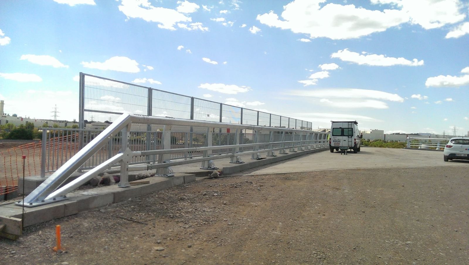 Parapet with mesh screen and end terminal